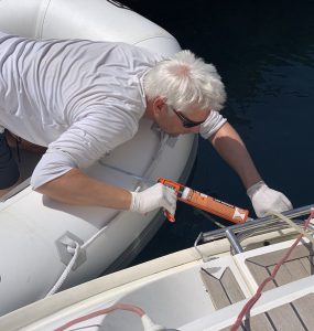 Man repairing a sail boat