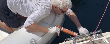 Man repairing a sail boat