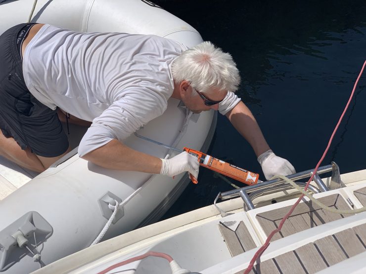 Man repairing a sail boat